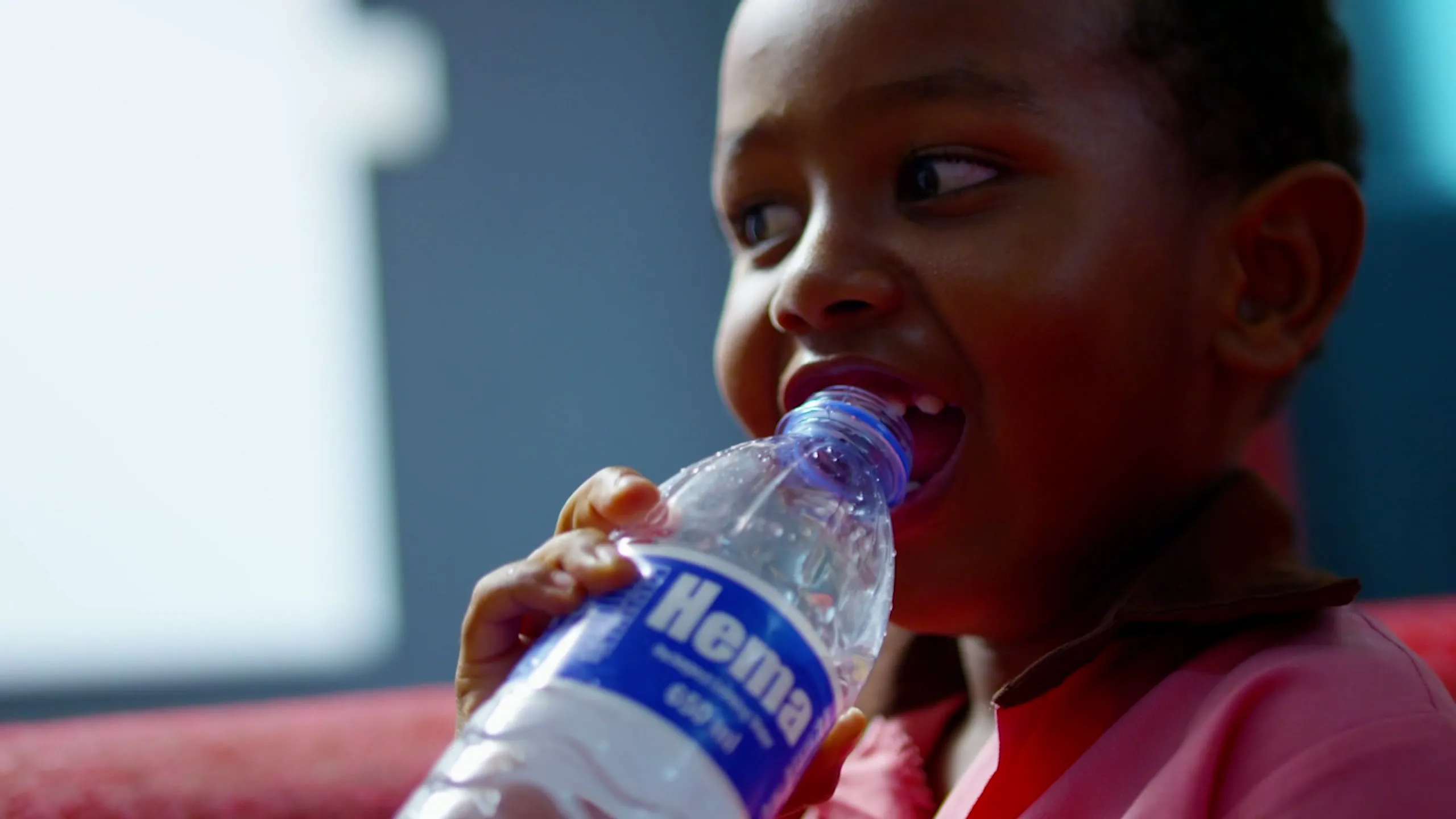 A child drinking HEMA packaged drinking water