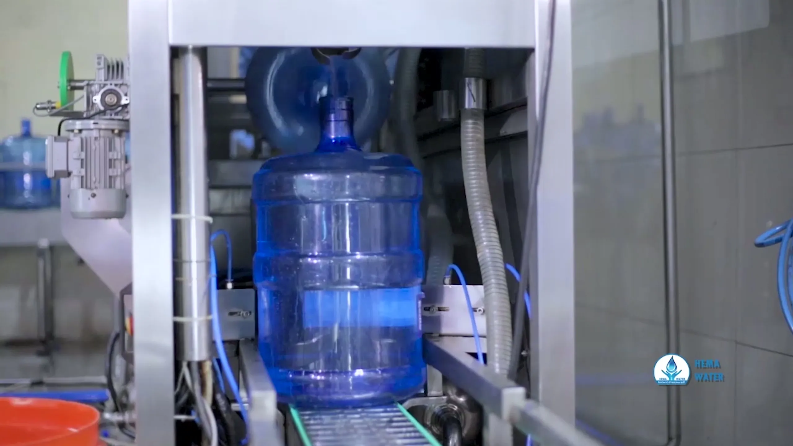 Capped HEMA bottles moving along the line